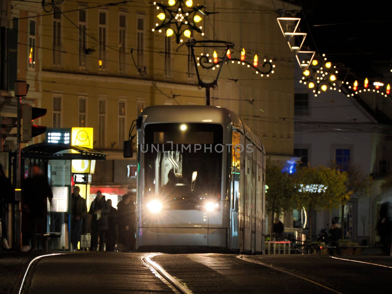 Night moving Trolley tram in graz austria tracks and cables in winter season by AndreaIzzotti