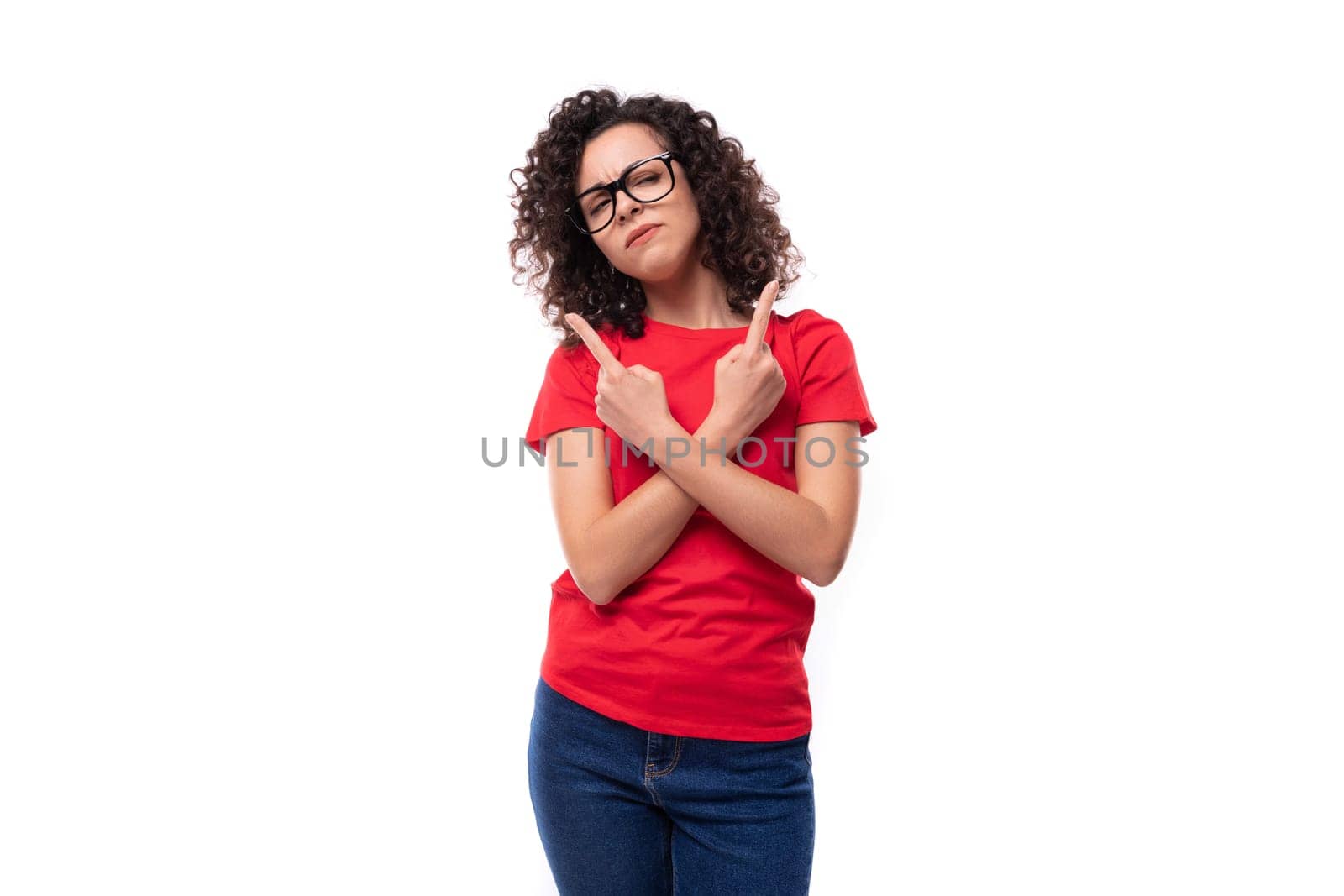 corporate clothing concept. young charming curly brunette woman dressed in red clothes on a white background with copy space.