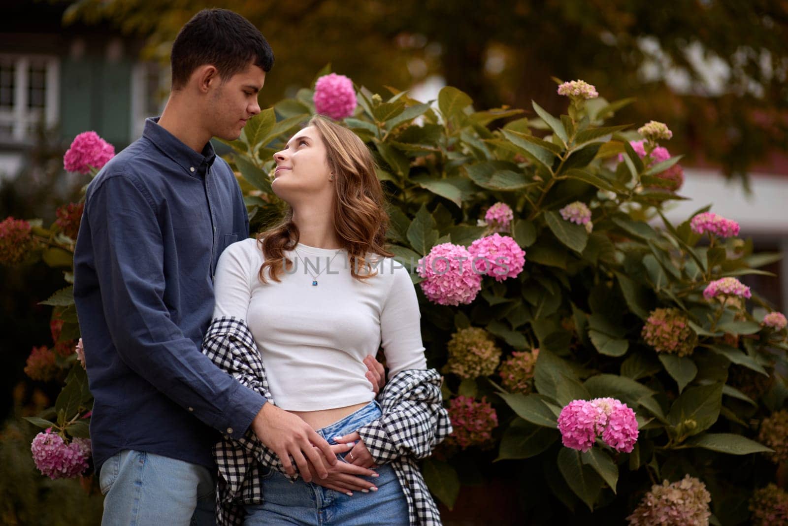 Young Cute Female Hugs Boyfriend. In Autumn Outdoor. Lovers Walking in Park. Attractive Funny Couple. Lovestory in Forest. Man and Woman. Cute Lovers in the Park. Family Concept. Happy Couple.