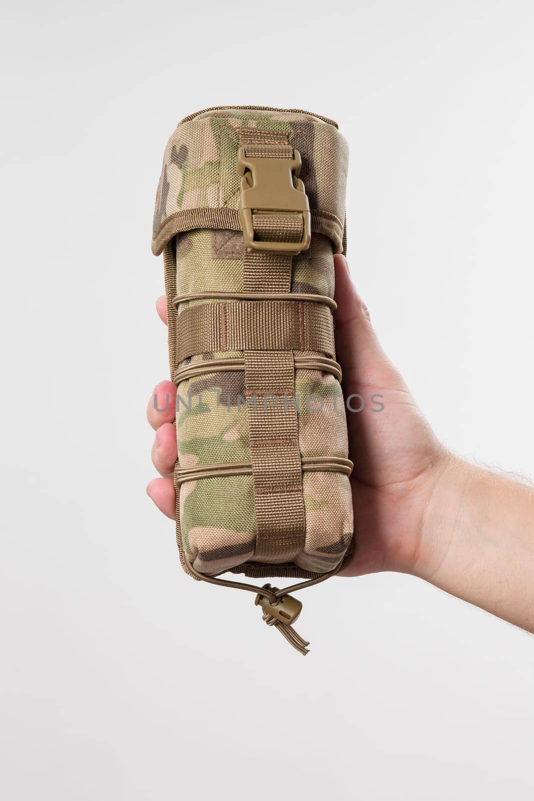 Man holding protective cover for monocular, military pixelated fabric, case isolated on white background.