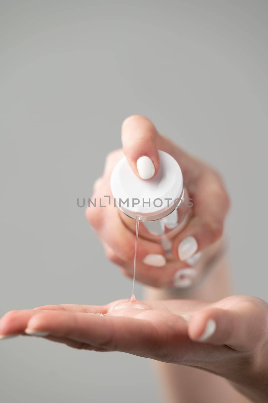 beautician squeezes cream from a jar onto his hand by Niko_Cingaryuk