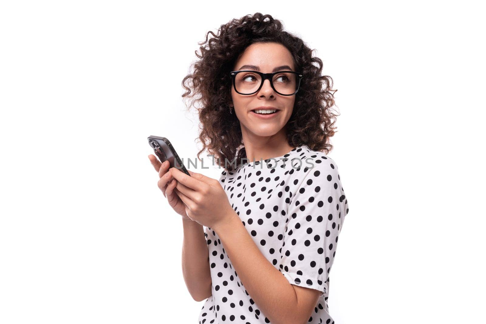 young leader woman with curly hairstyle dressed in summer blouse chatting on the phone by TRMK