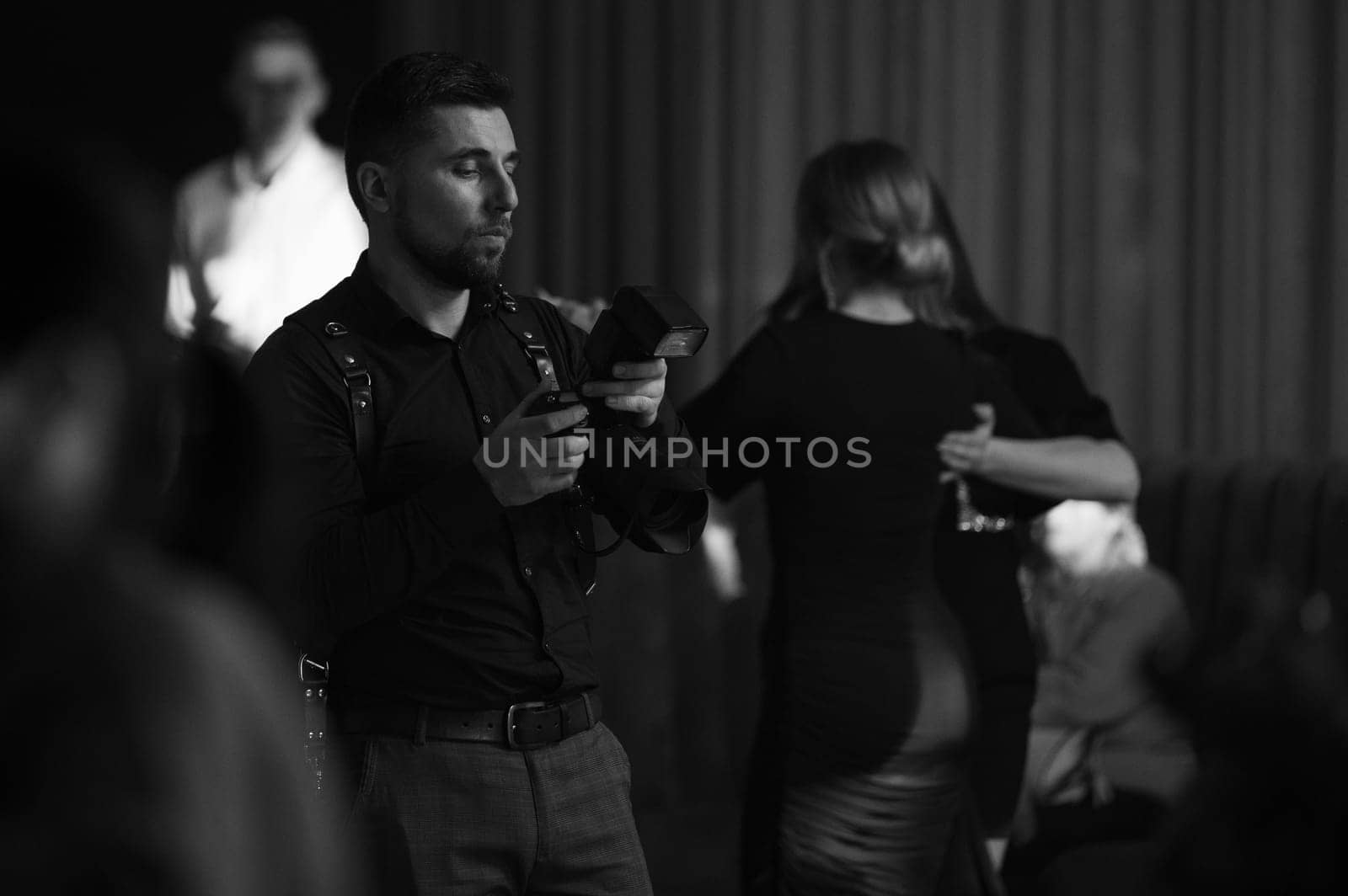 A photographer at work, the process of shooting and photographing celebrations. Paparazzi conducts a journalistic investigation at a party. by Niko_Cingaryuk
