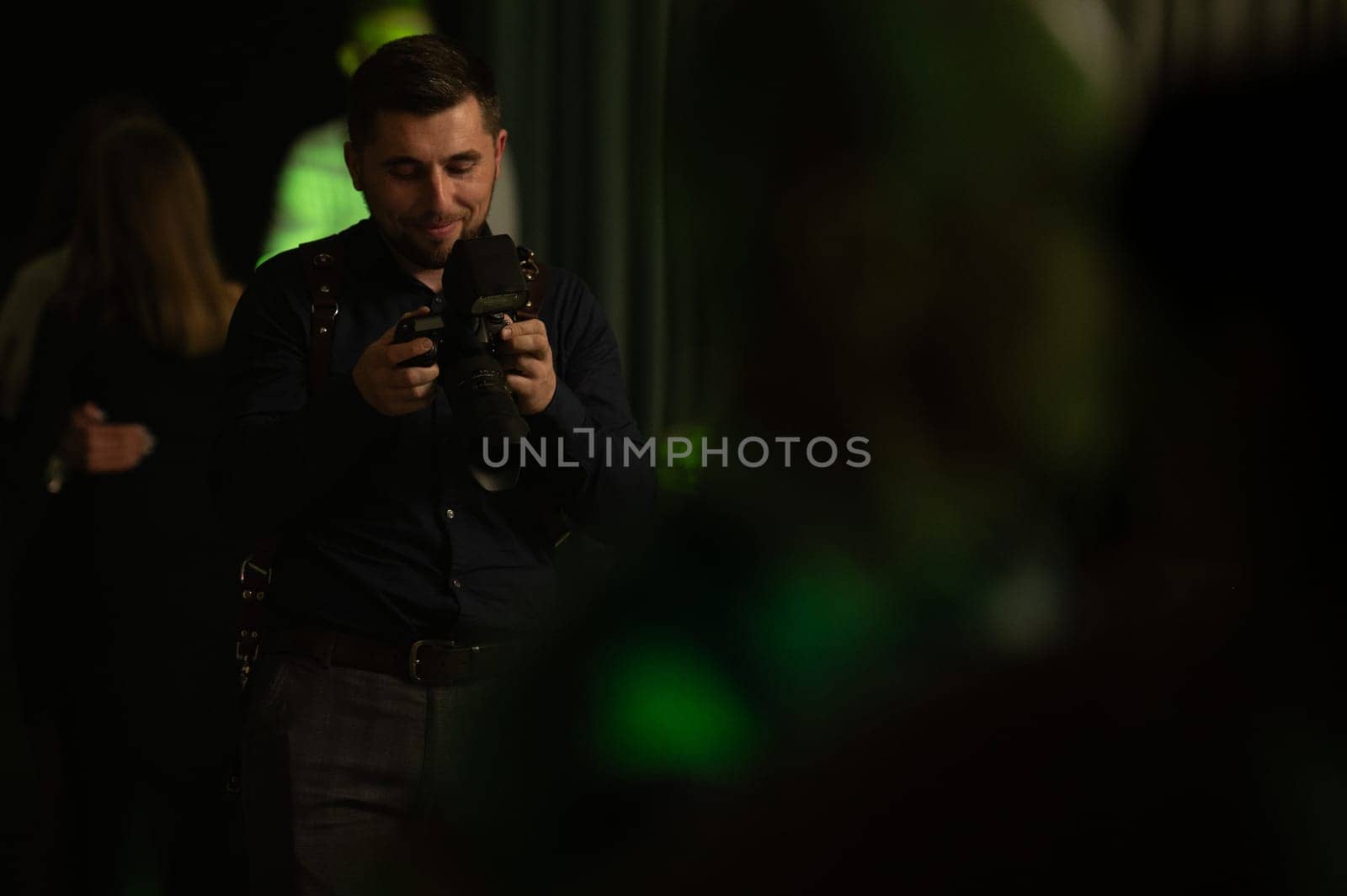 A photographer at work, the process of shooting and photographing celebrations. Paparazzi conducts a journalistic investigation at a party. by Niko_Cingaryuk