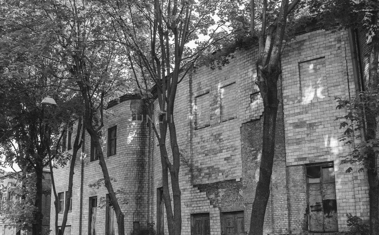 Abandoned building old architecture black and white photo. Brick destroyed building photography. Street scene. High quality picture for wallpaper, travel blog.