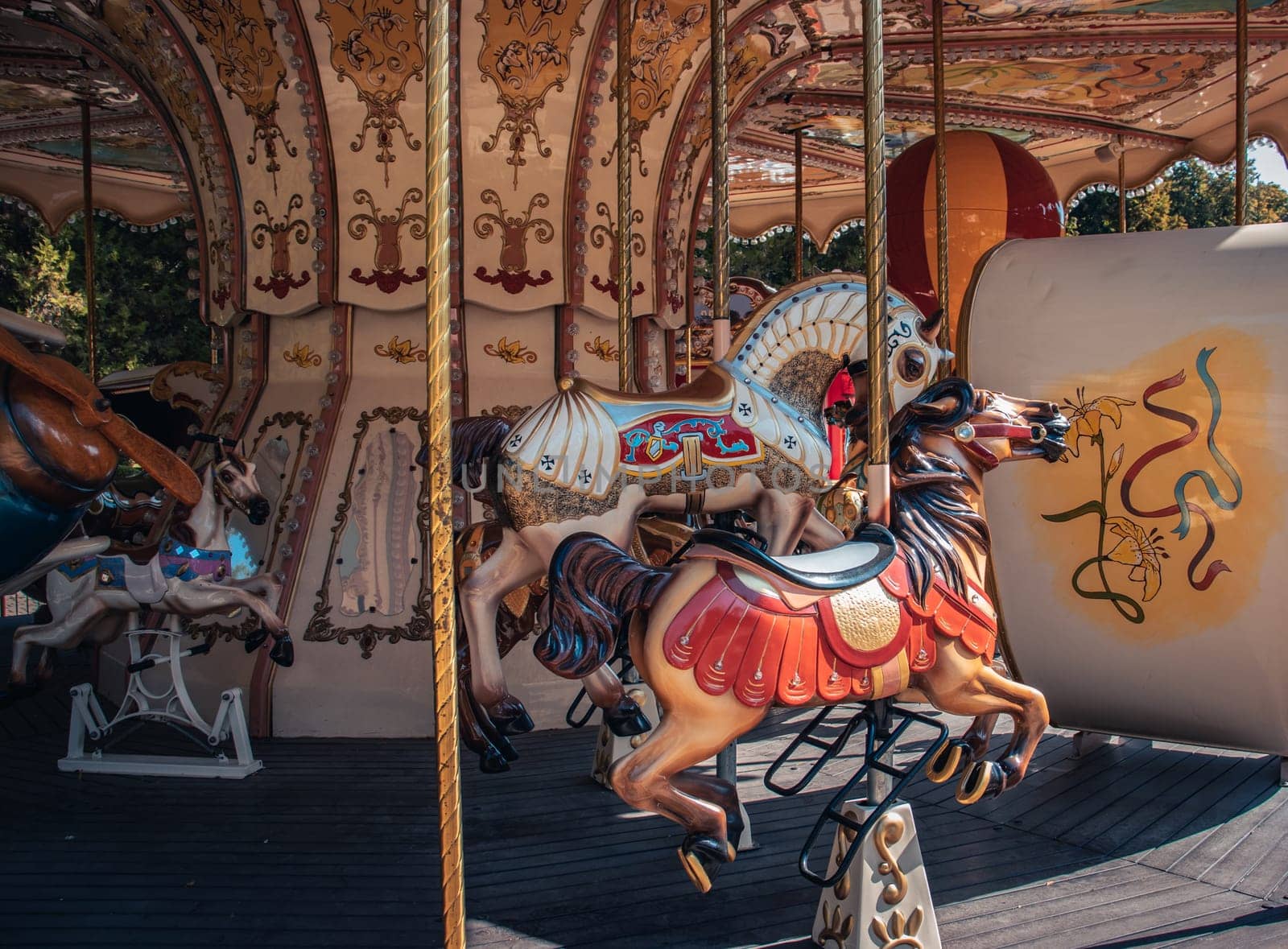 Vintage fair horse carousel in amusement park concept photo. Front view photography with blurred background. High quality picture for wallpaper, travel blog, magazine, article