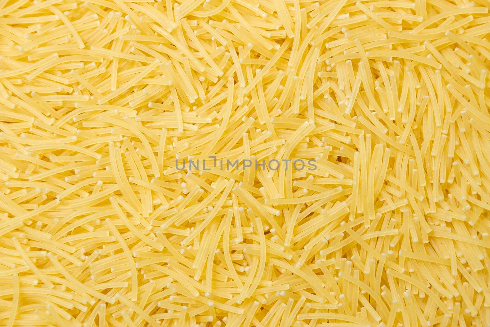 Uncooked Filini Pasta: A Culinary Canvas of Noodles, Creating a Lively and Textured Background for Gourmet Cooking. Dry Pasta. Raw Macaroni - Top View, Flat Lay