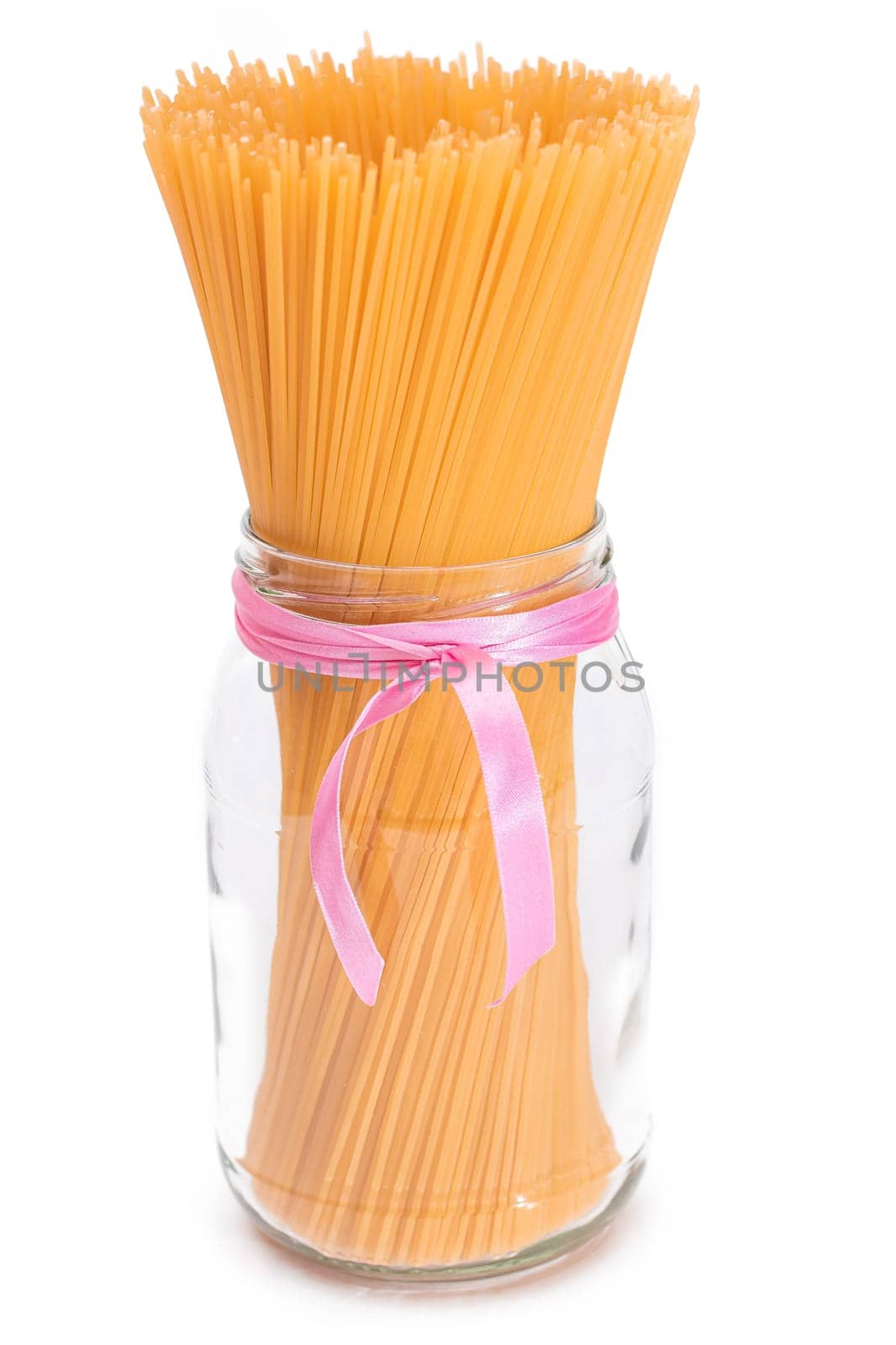 Dry Uncooked Spaghetti in a Glass Jar Isolated on White Background by InfinitumProdux