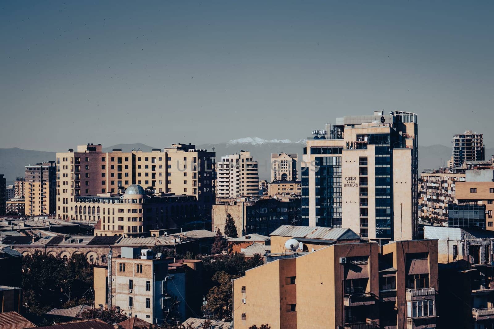 Cityscape in a morning time view in full color concept photo. Beautiful urban scenery with far mountains peak photography. District scene. High quality picture for magazine, article