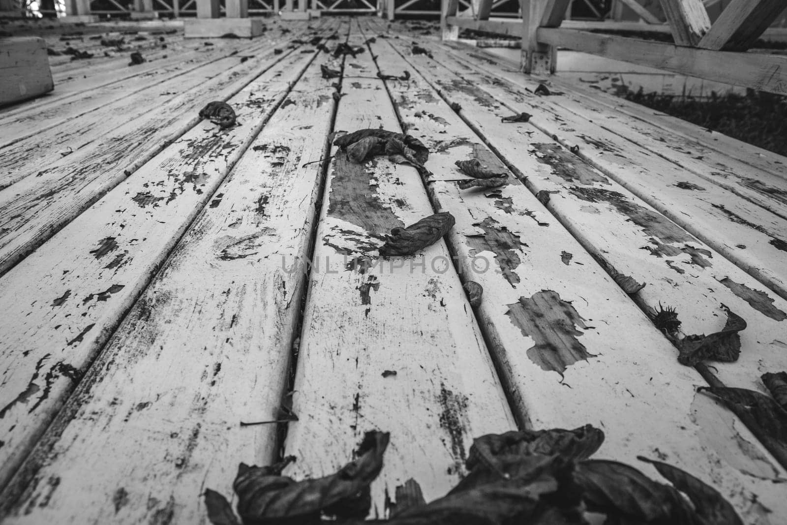 Vintage old black and white wooden textured floor concept photo. View of the wooden white gazebo in the garden. Parkland of European town. High quality altanka picture for wallpaper