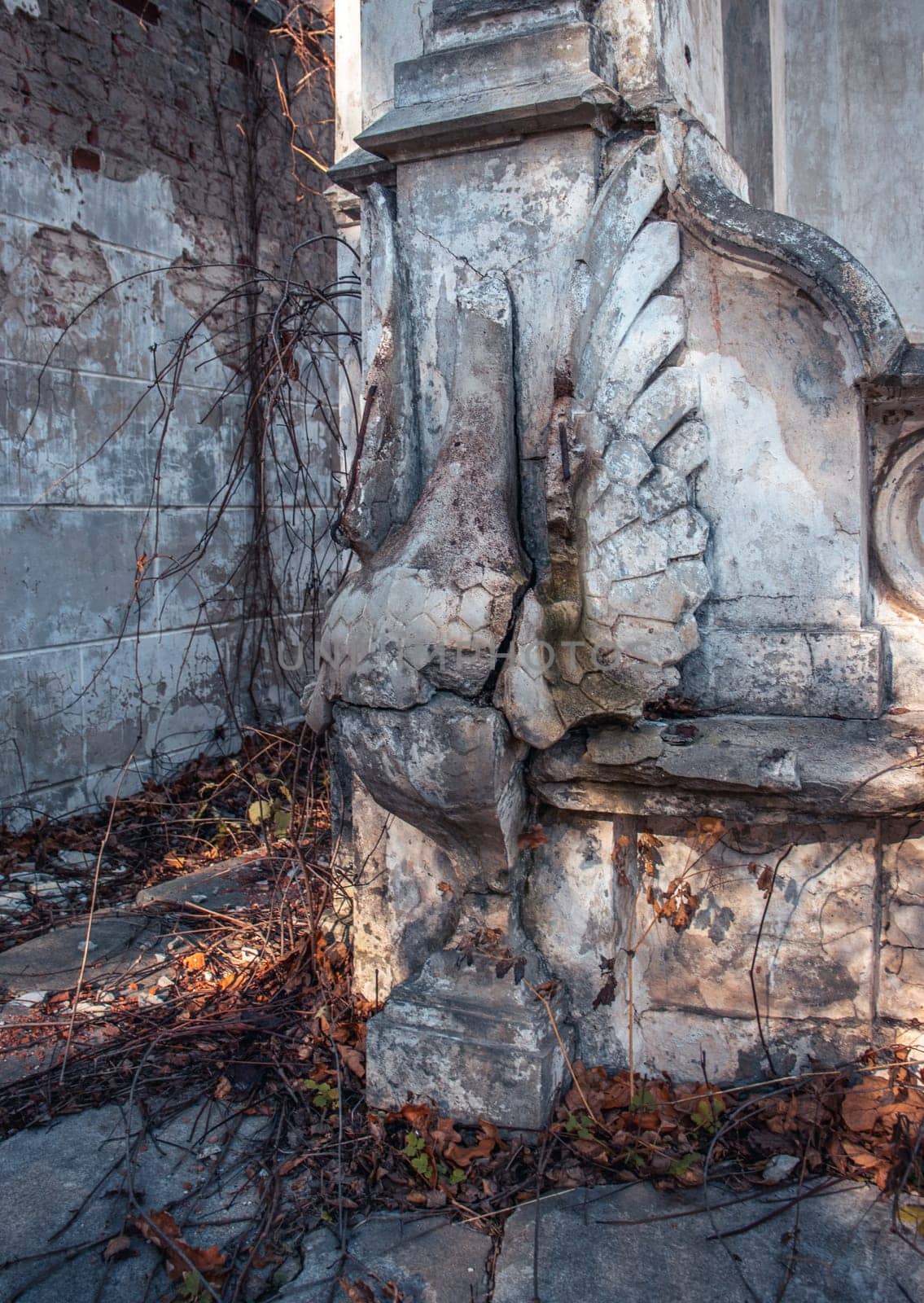 Destroyed swan statue on the yard concept photo. Castle ruins terrace view. Ruined ancient palace in Ukraine. A beautiful historical building in a European city.