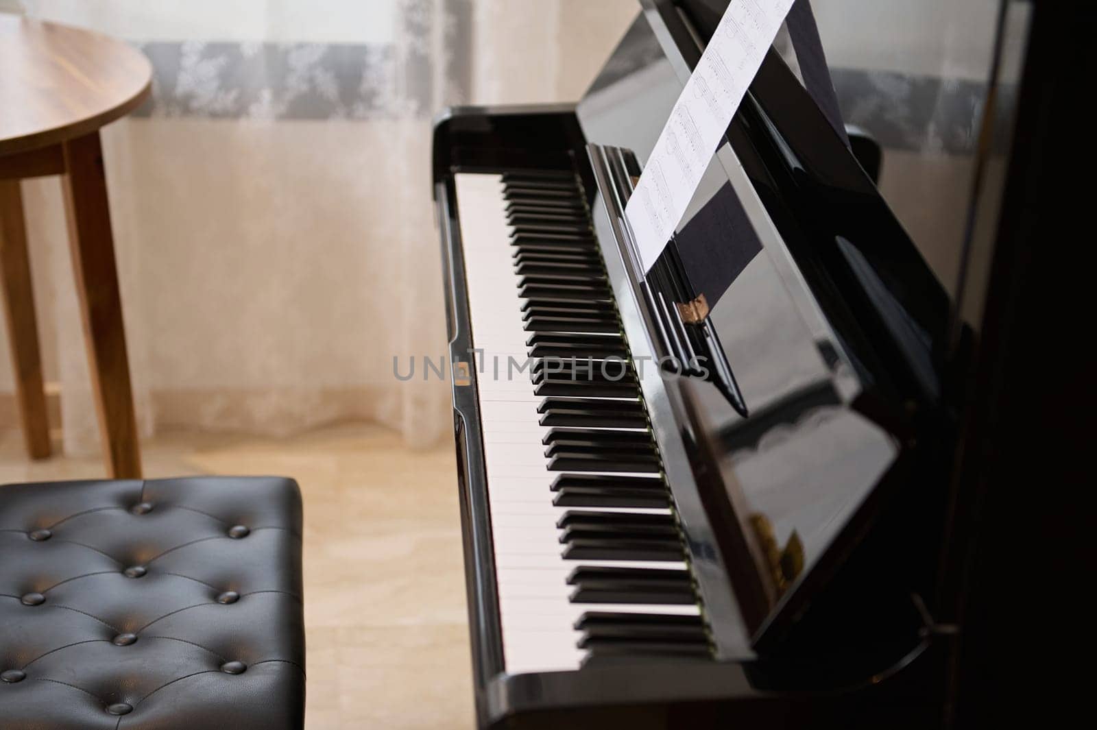 Still life. Old piano with open wooden keyboard, with black and white keys in empty music class. Learning music and playing on classic luxury vintage chord musical instrument. Copy advertising space