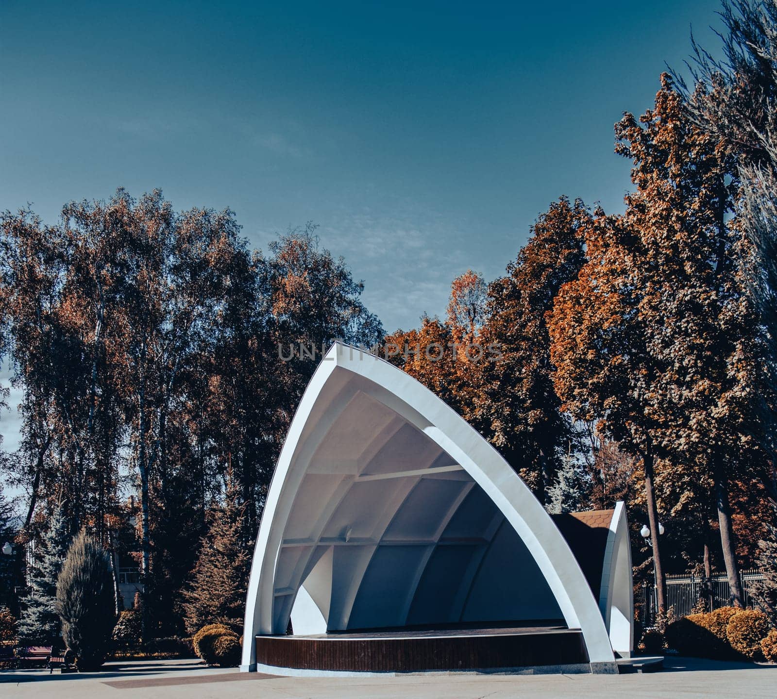 Park outdoor opening cinema theatre concept photo. Theater in autumn with trees in parkland by _Nataly_Nati_