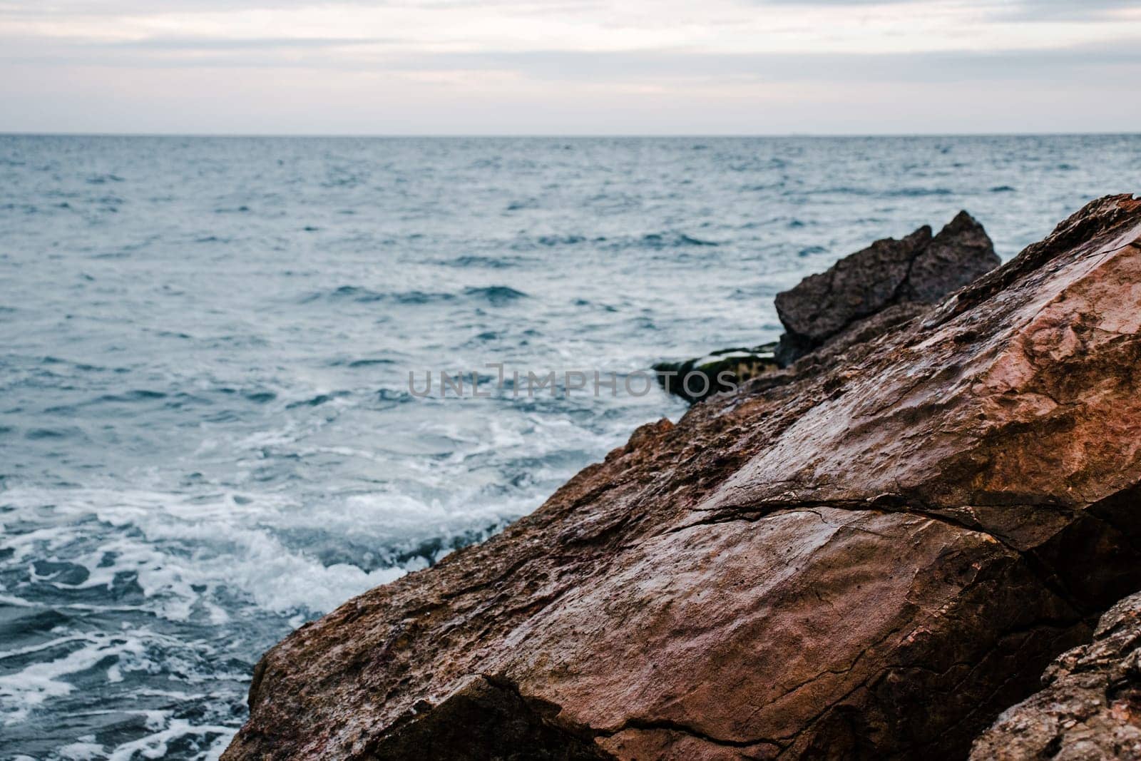 Winter sea with stones on the beach concept photo. Underwater rock. Mediterranean sea. The view from the top, nautical background. High quality picture for wallpaper