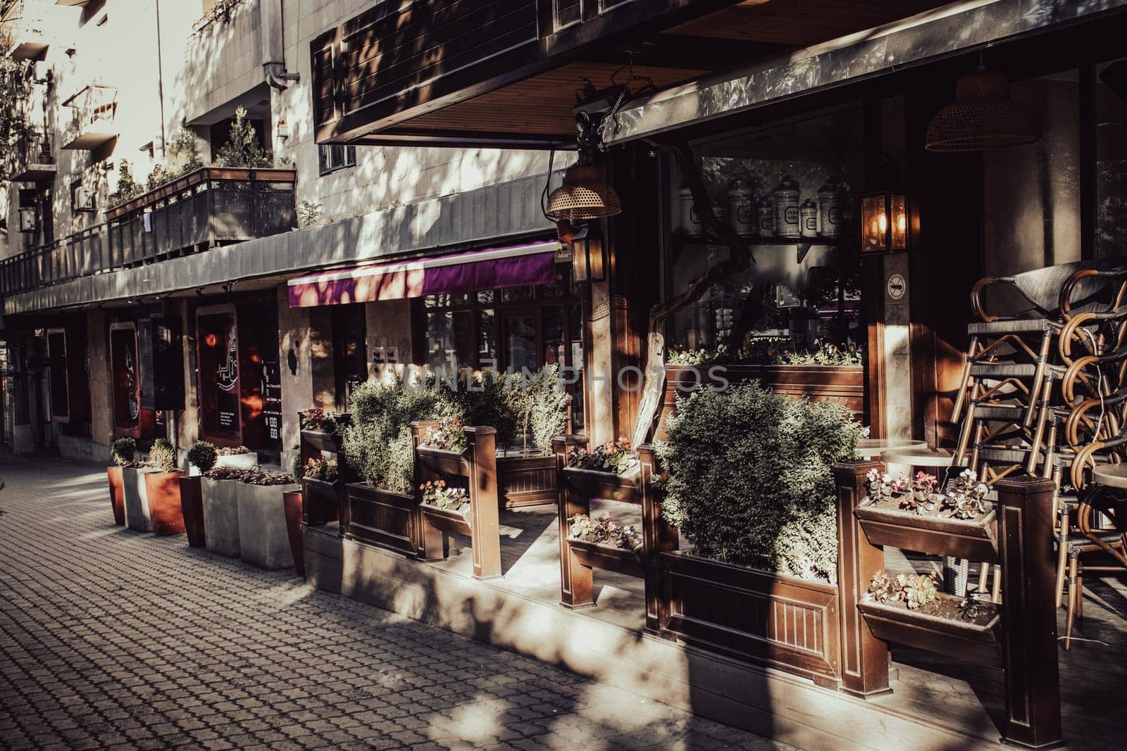 Street view with beautiful buildings and cafe terrace during the morning light concept photo. One of the streets of Yerevan. Magic country Armenia. District scene. High quality picture for magazine, article