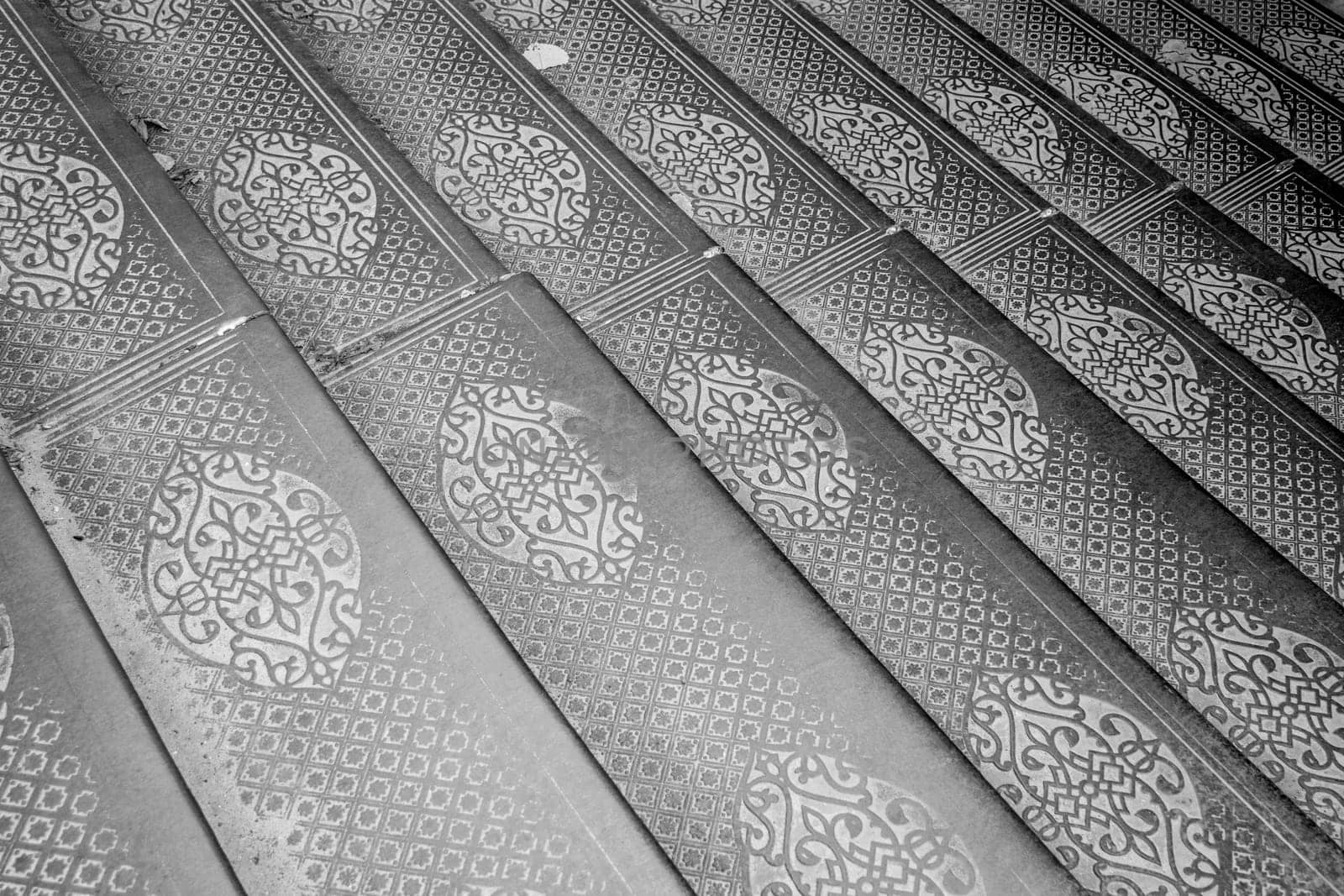Ornate steel plate industrial staircase concept photo. Metal floor plate, steel staircase. District of European town. High quality picture for wallpaper. Suitable for background images and abstract illustrations.
