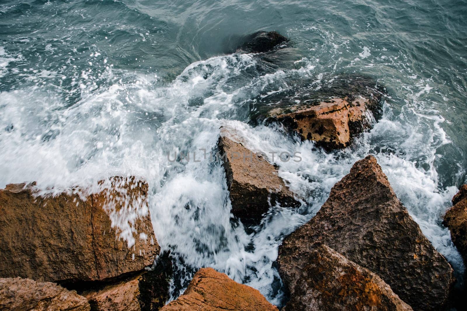 Winter stormy seaside close up concept photo. Water with stones on the beach. Underwater rock. by _Nataly_Nati_