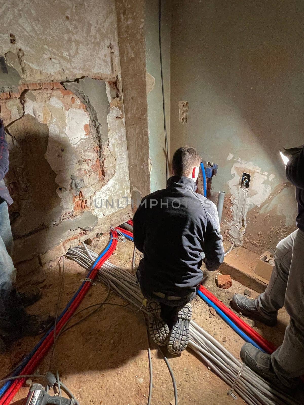 Electrician working working on building site, Maintenance technicians install wiring in the home. High quality photo