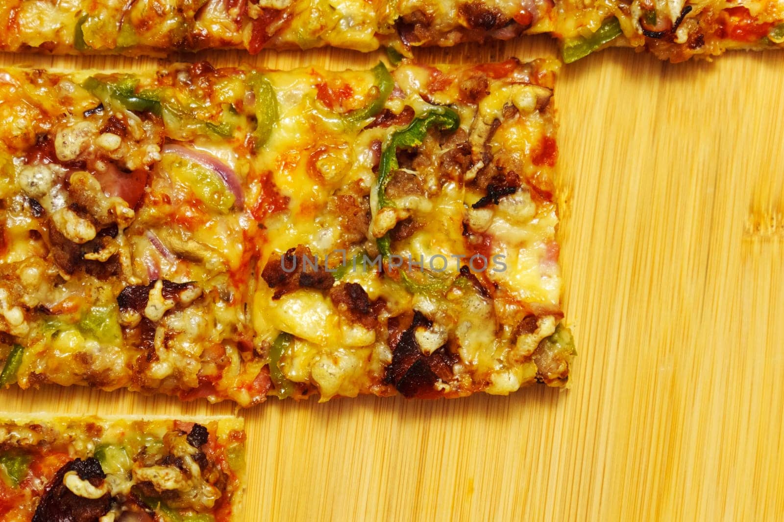 St. Louis-Style Pizza on a plate, cut into squares, on a wooden background.