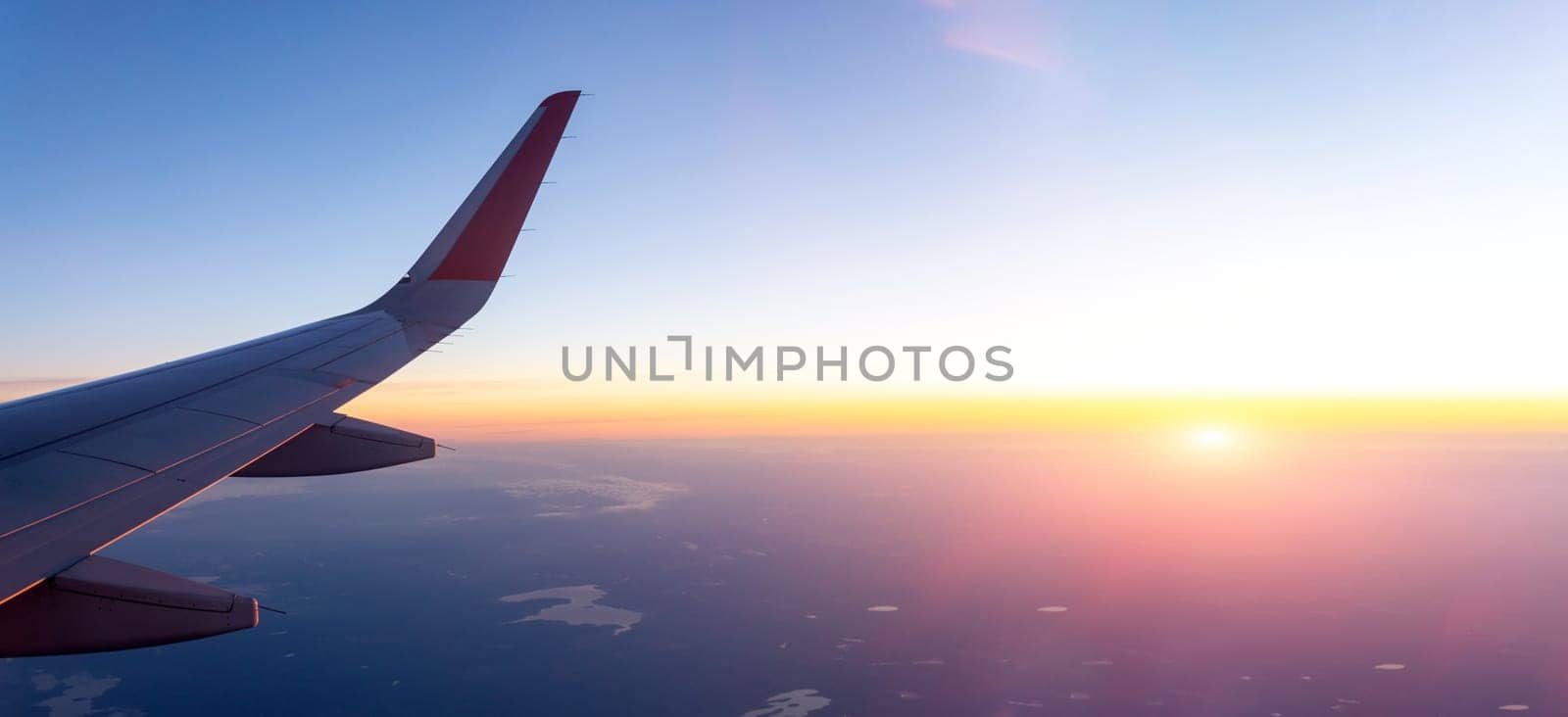 Airplane Wing Soaring Through the Sky. Banner copy space by darksoul72