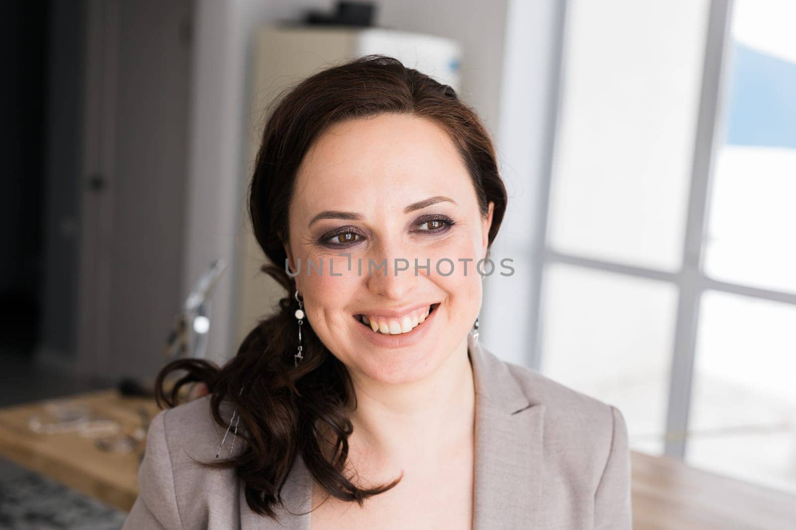 Portrait of a female online store business owner looking away and smiling. Woman doing her small business from home. Copy space and empty place for text by Satura86