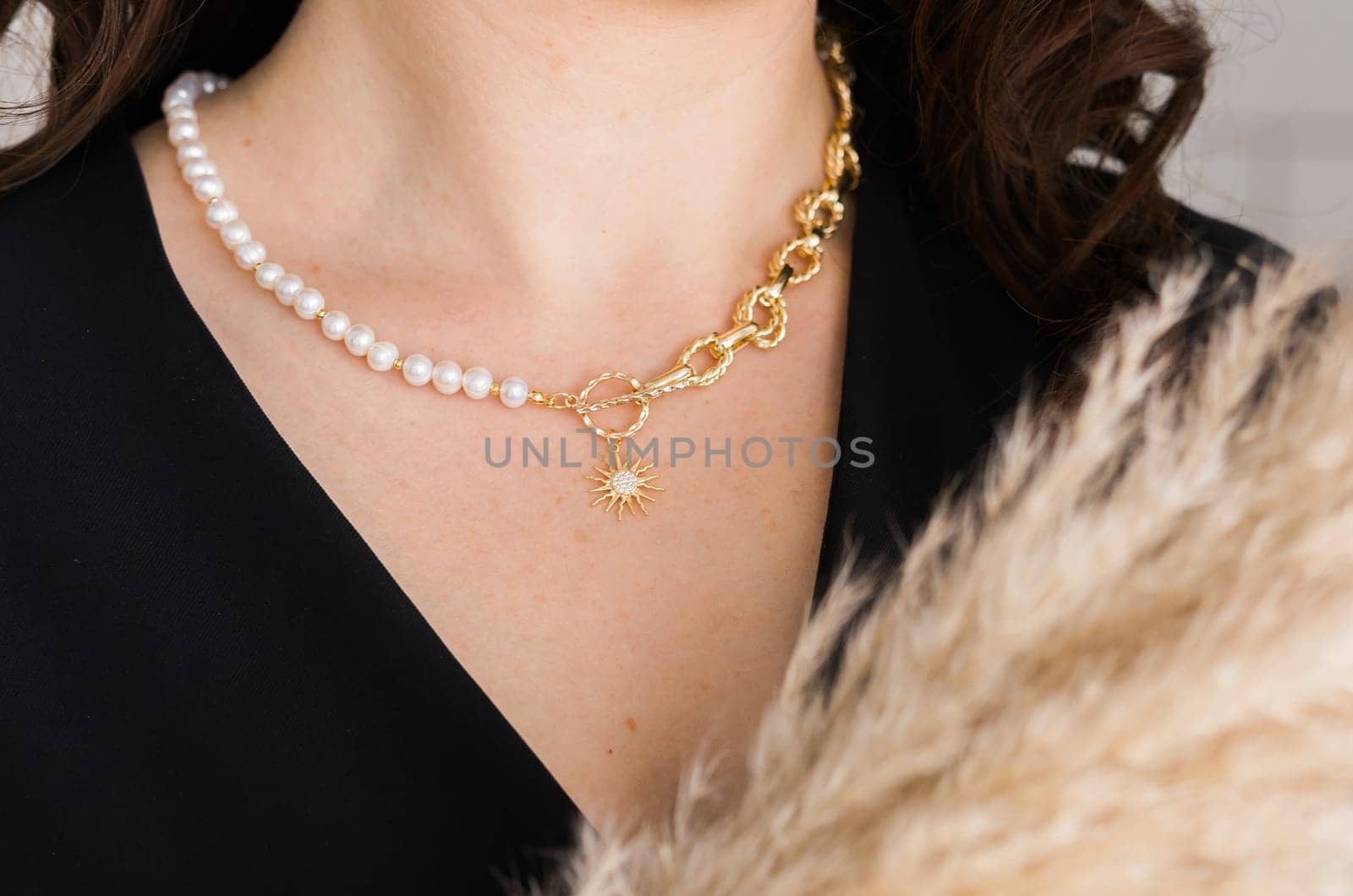 Close-up woman wearing beautiful luxury big necklace. Handmade jewellery and accessories.