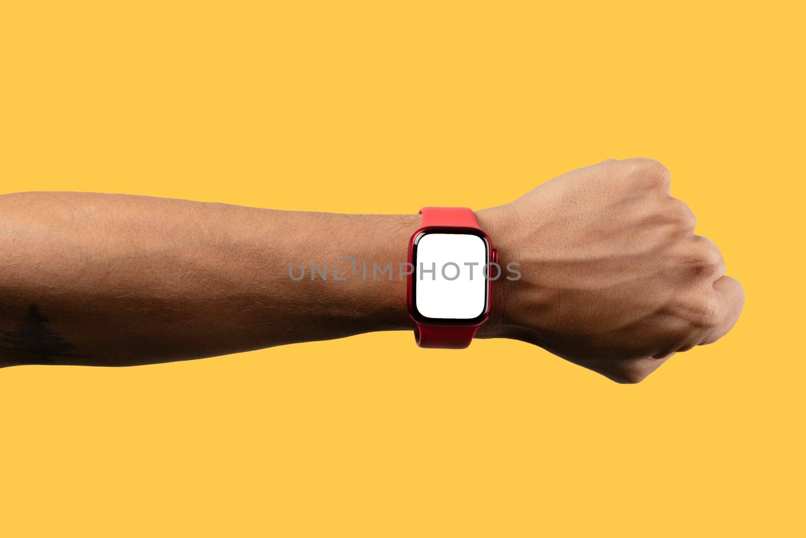 black male arm wearing red smartwatch with blank screen isolated on yellow by TropicalNinjaStudio