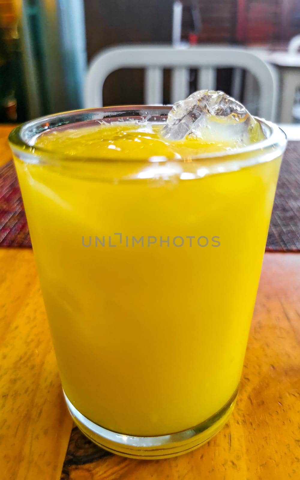 Orange fruit juice in restaurant PapaCharly Playa del Carmen Mexico. by Arkadij