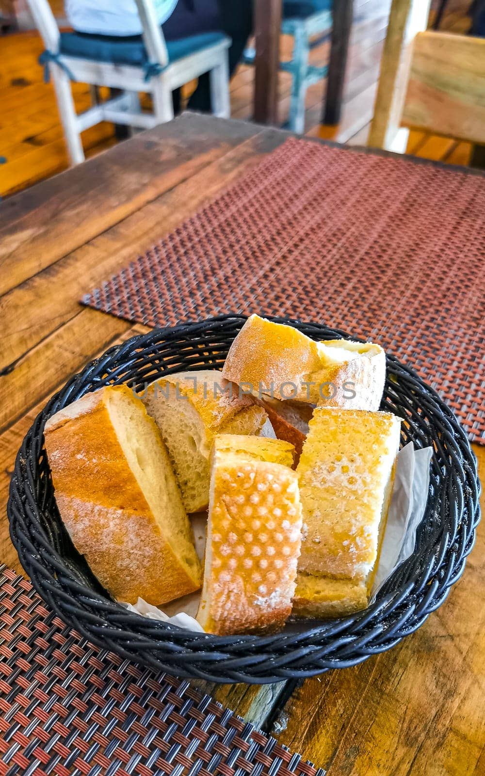 Bread in basket on wooden table dish meal food and drink in the restaurant PapaCharly Papa Charly in Playa del Carmen Quintana Roo Mexico.