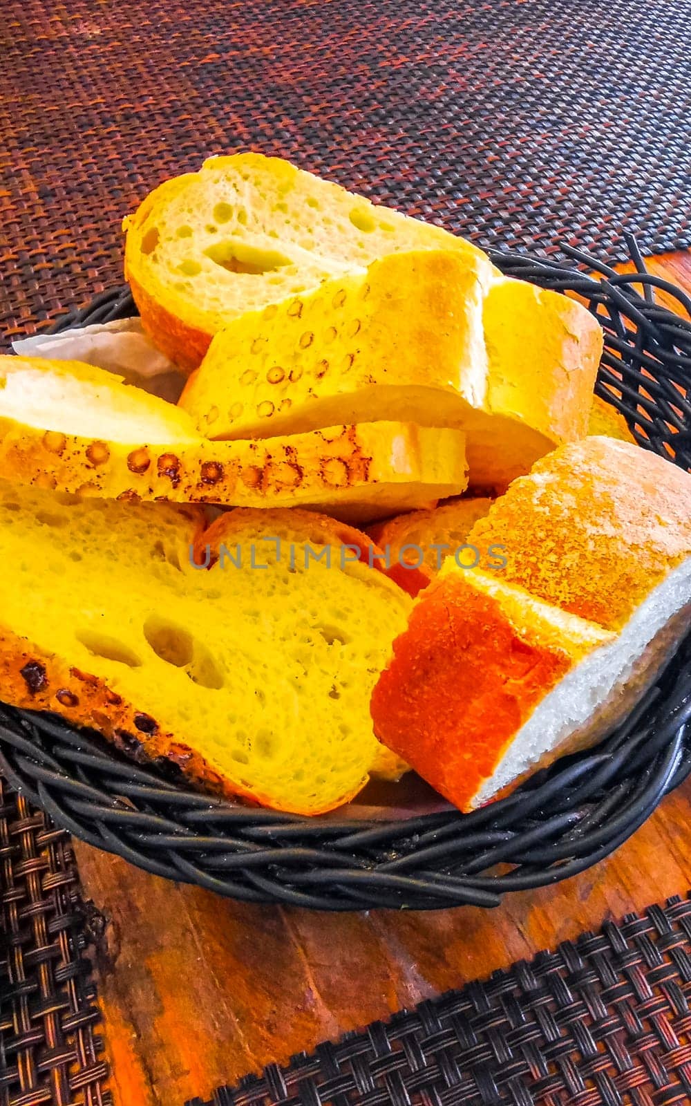 Bread in basket on wooden table dish meal food and drink in the restaurant PapaCharly Papa Charly in Playa del Carmen Quintana Roo Mexico.