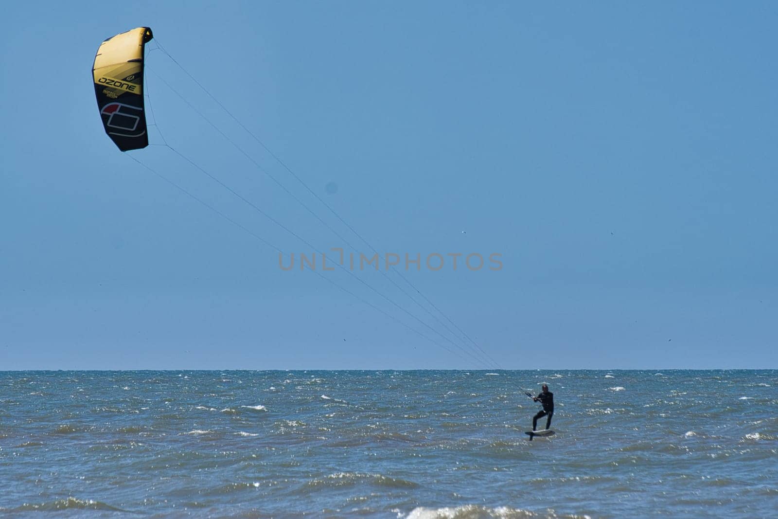 Kitesurfer in the still sea waters of beach Scheveningen in the Netherlands by rherrmannde