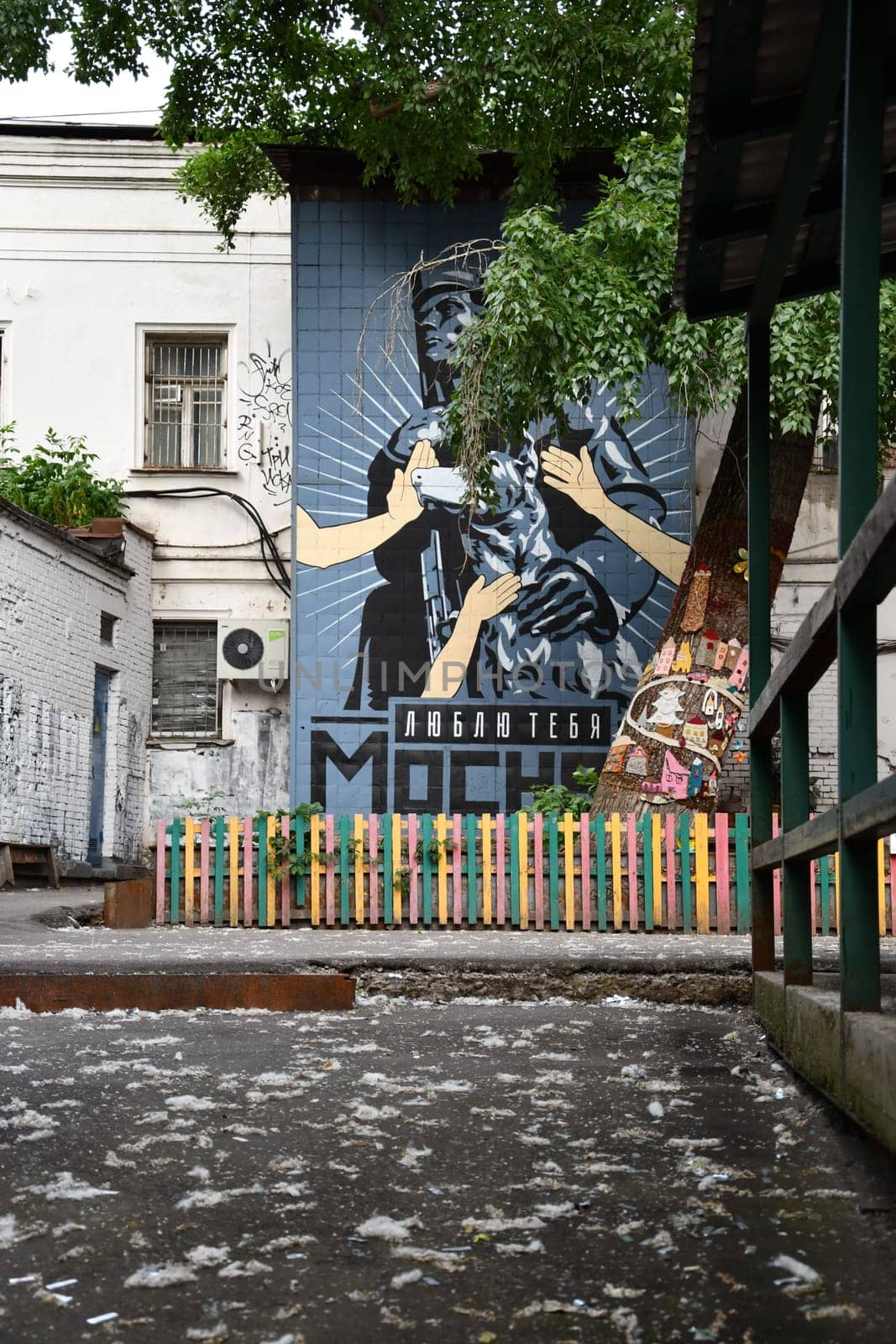 Vertical shot of graffiti on a building wall in backyard