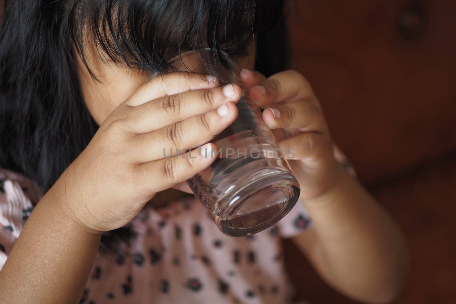 child hand holding a glass of water by towfiq007