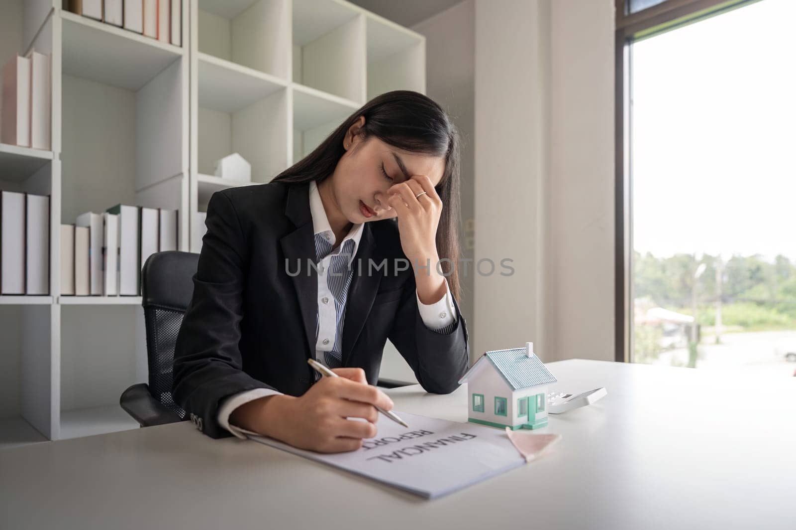 Asia Business woman stress from work investment in real estate, There are financial problem with installments with the bank.