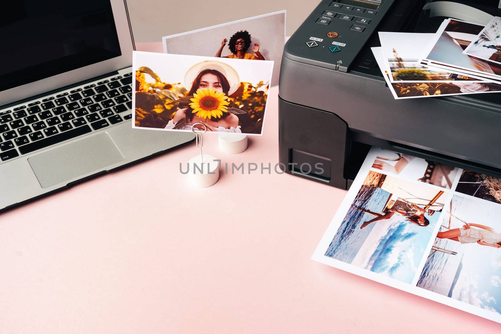 Computer laptop and printer on the table. Printing photos