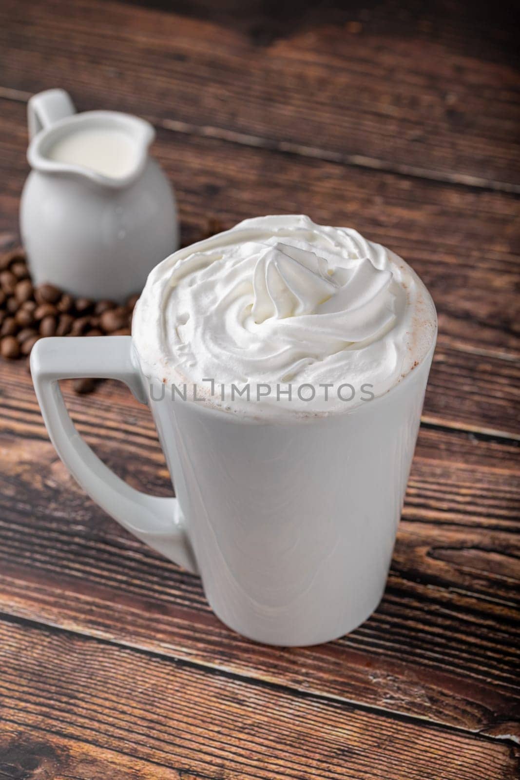 Cafe mocha in white porcelain cup on wooden table