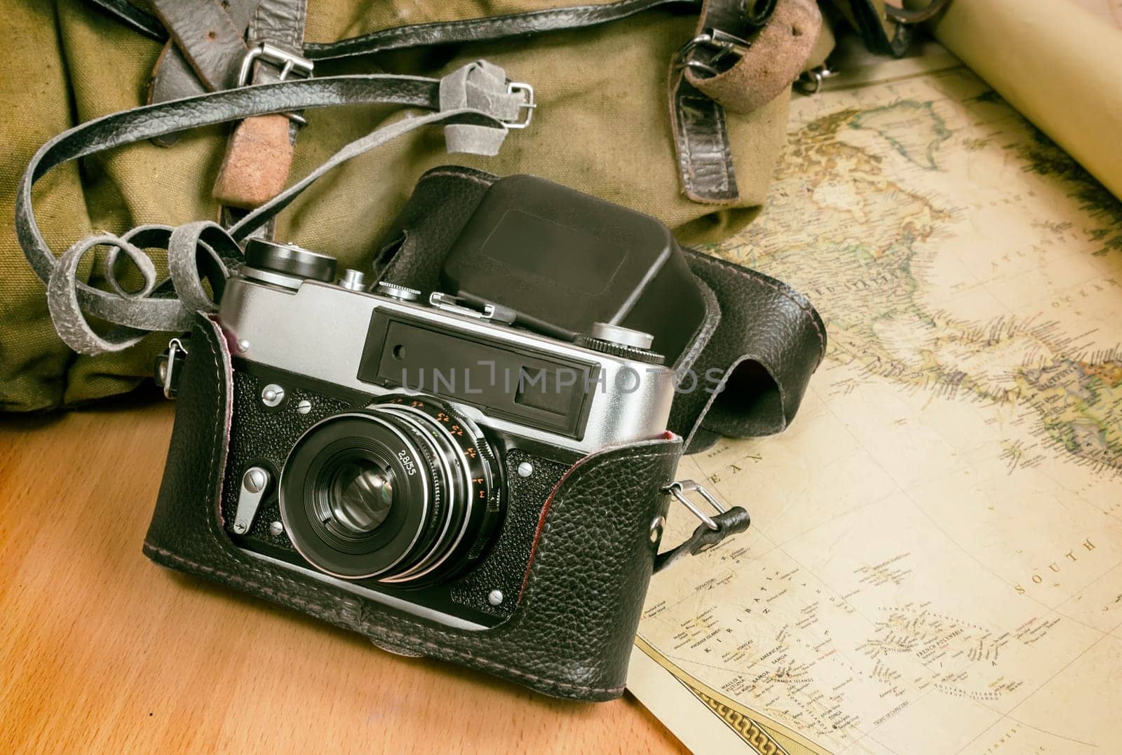Items needed for travel: a large backpack, camera, map of the world. Vintage items in retro style.