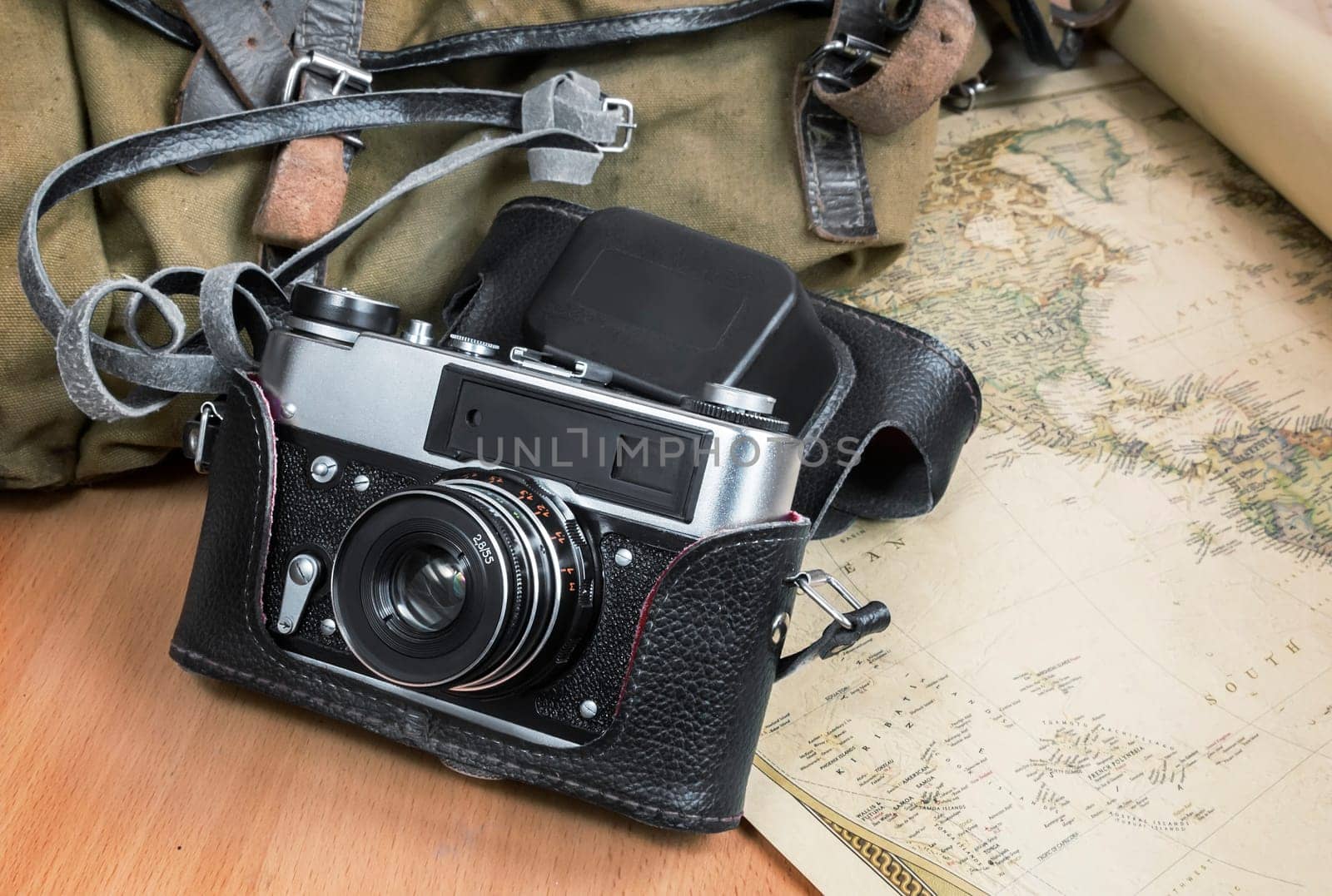 Items needed for travel: a large backpack, camera, map of the world. Vintage items in retro style