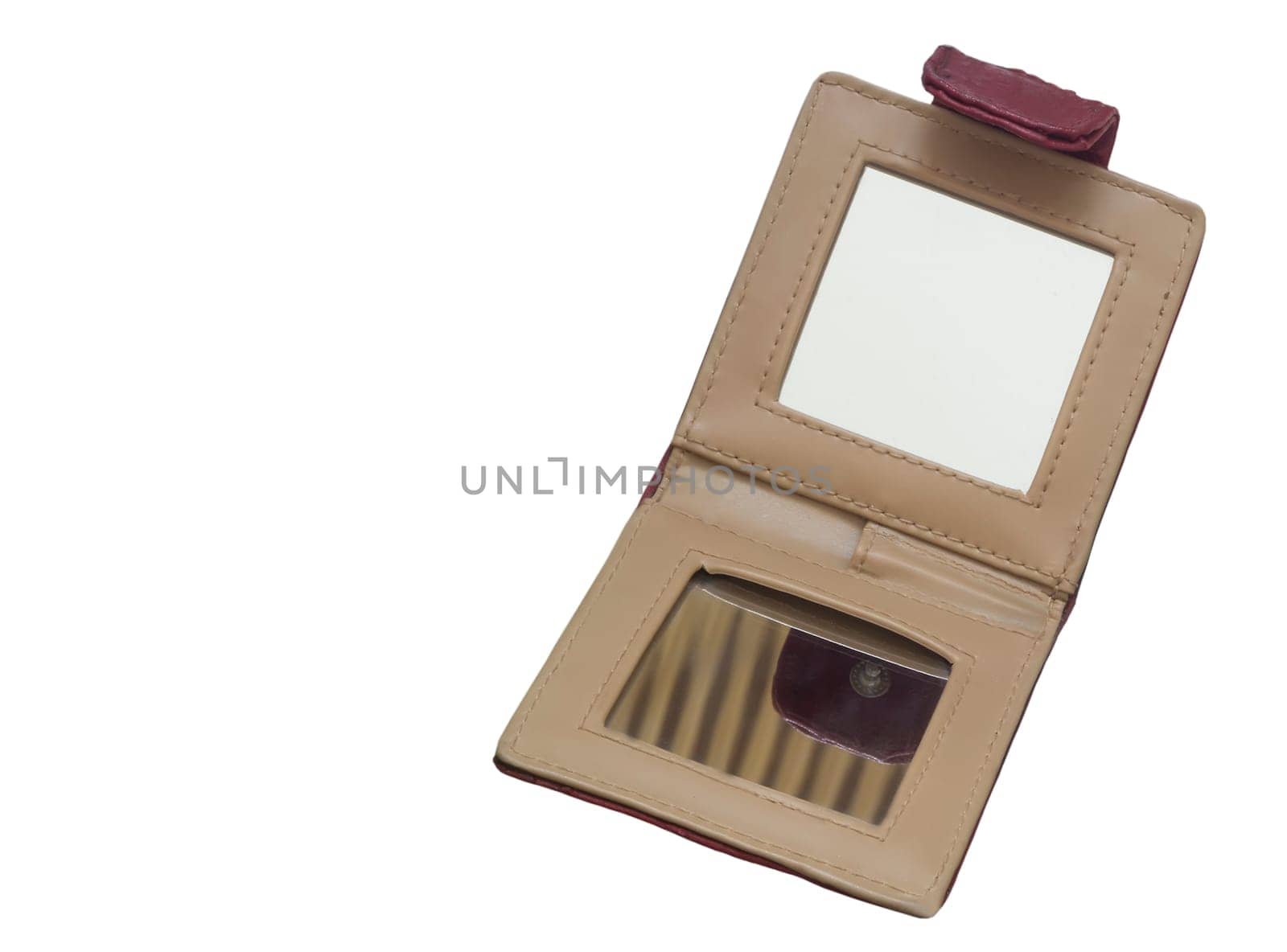 Folding mirror compact for women on a leather cover. Presented on a white background.