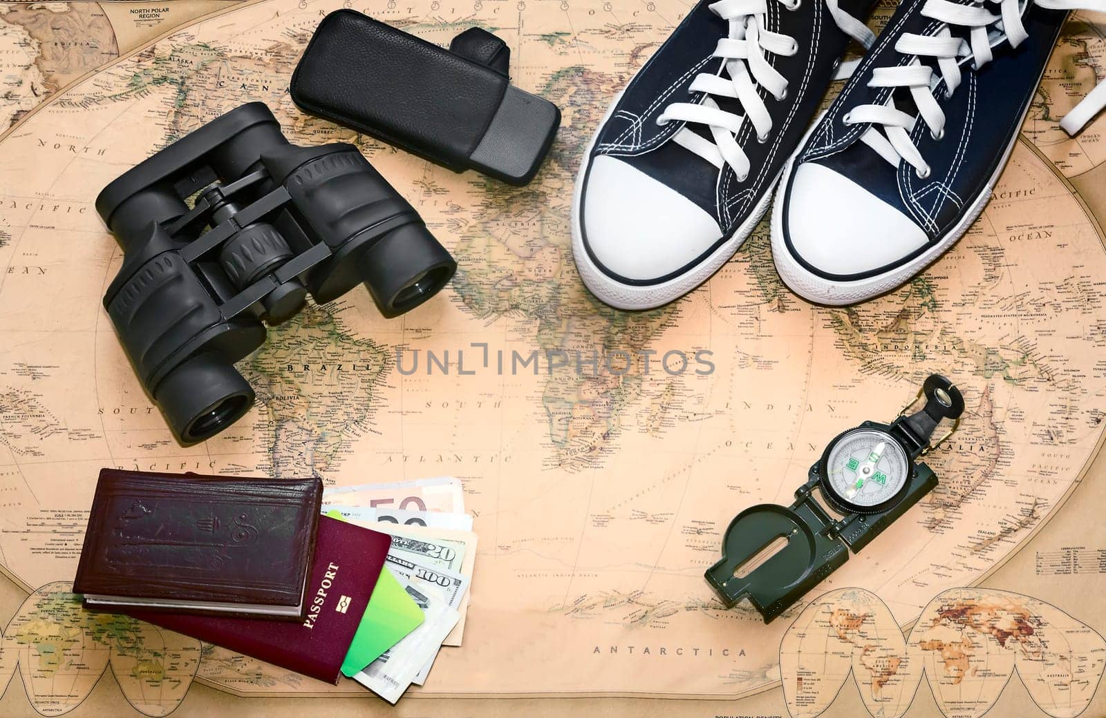 Items needed for the journey: a compass, binoculars, phone, passport, money, sneakers. Located on a world map background