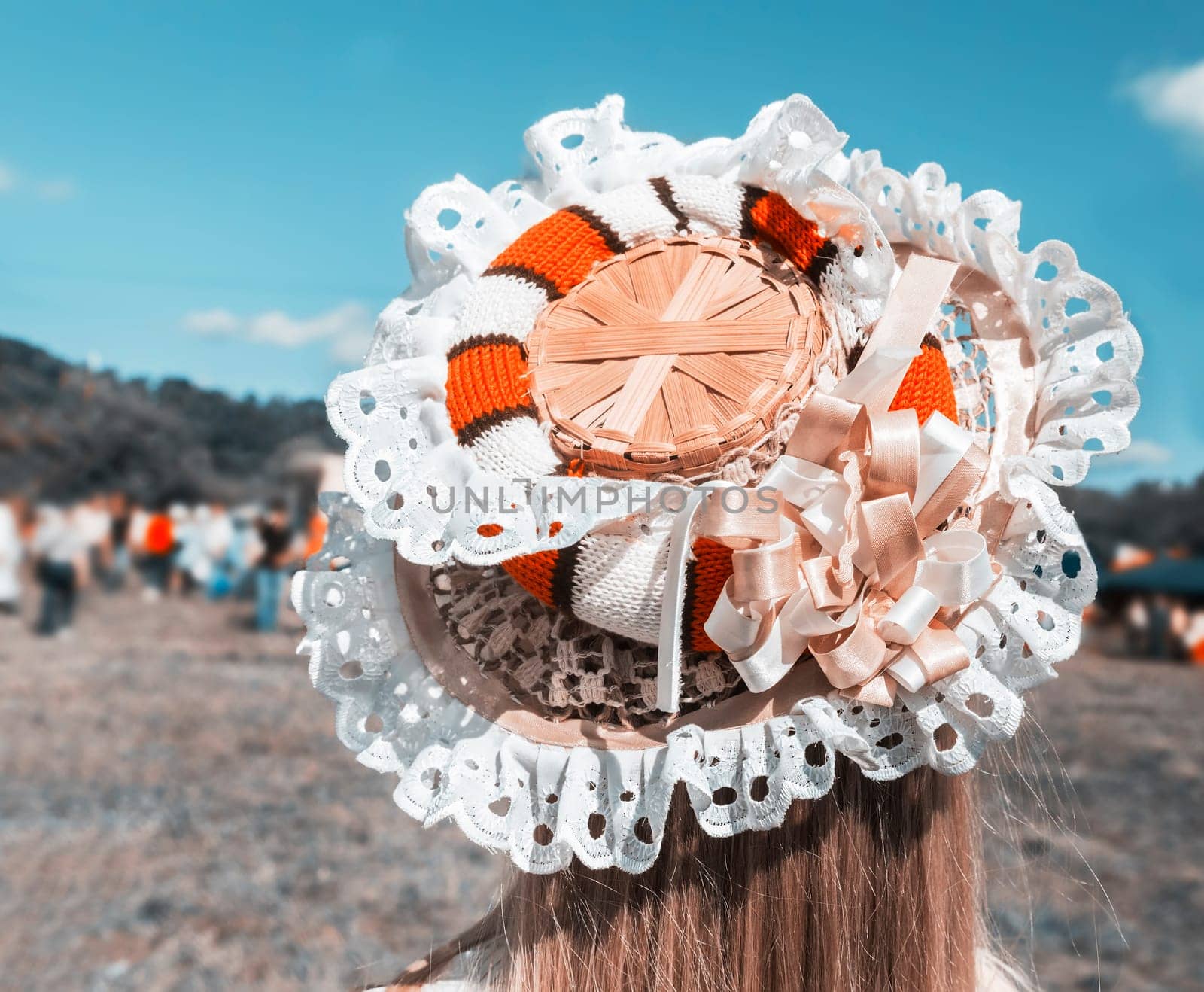 On the girl's head is an original hat, decorated with lace and ribbons.