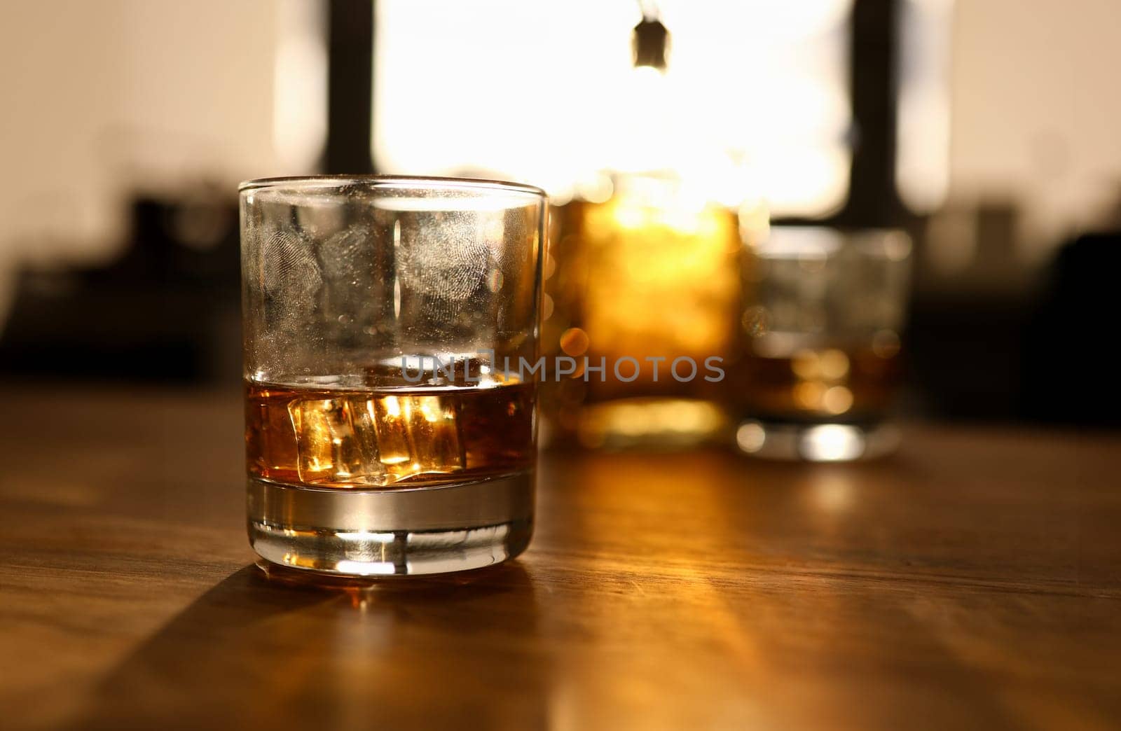 Fingerprint on glass with whiskey stands wooden by kuprevich
