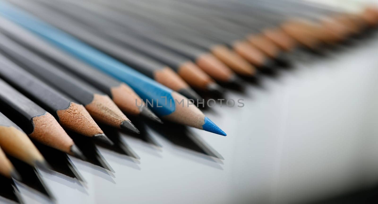 Blue pencil spy between black pencils by kuprevich