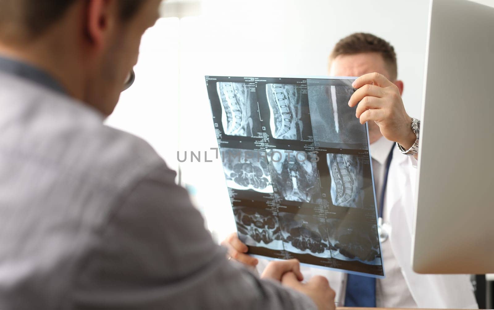 Doctor hold xray bone spine radiography in hand by kuprevich