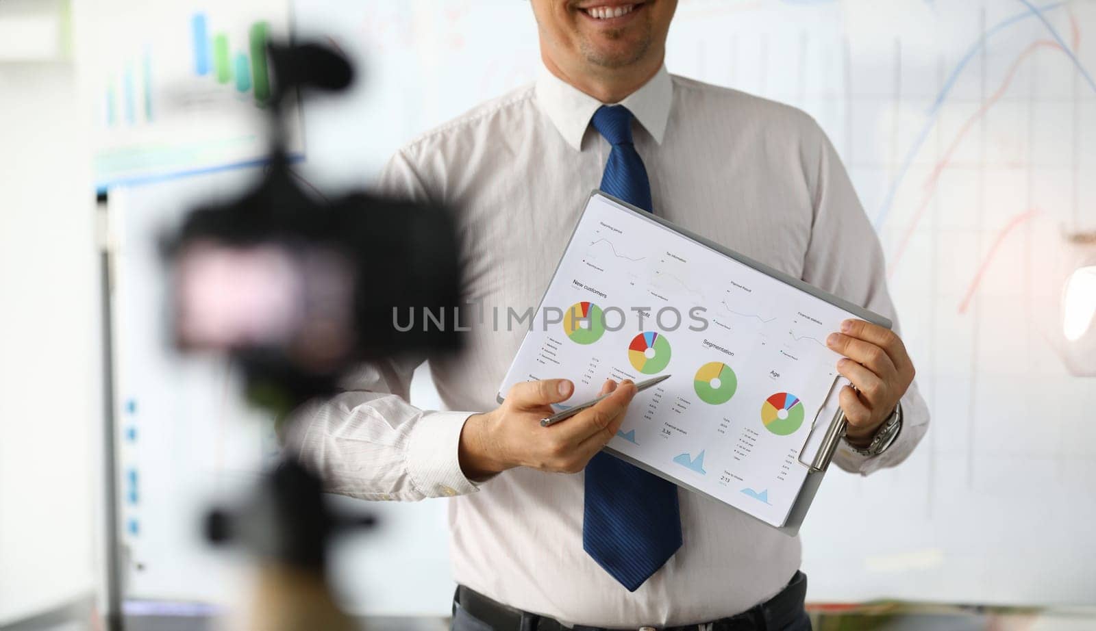 Male hand hold clipboard with business chart closeup. Online workshop broadcast. Webinar for business people concept.