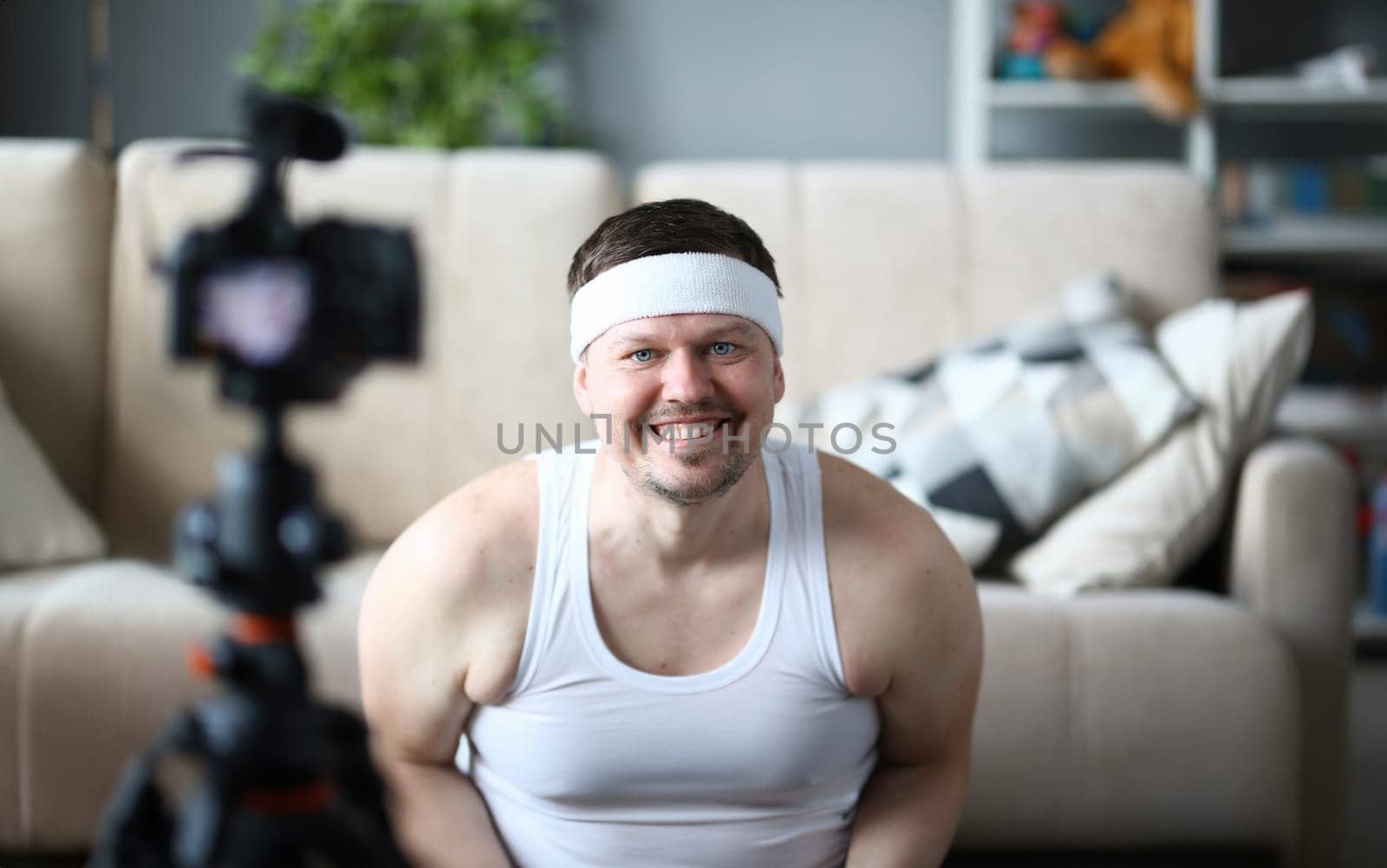 Smiling Vlogger Recording Fitness Video on Camera by kuprevich