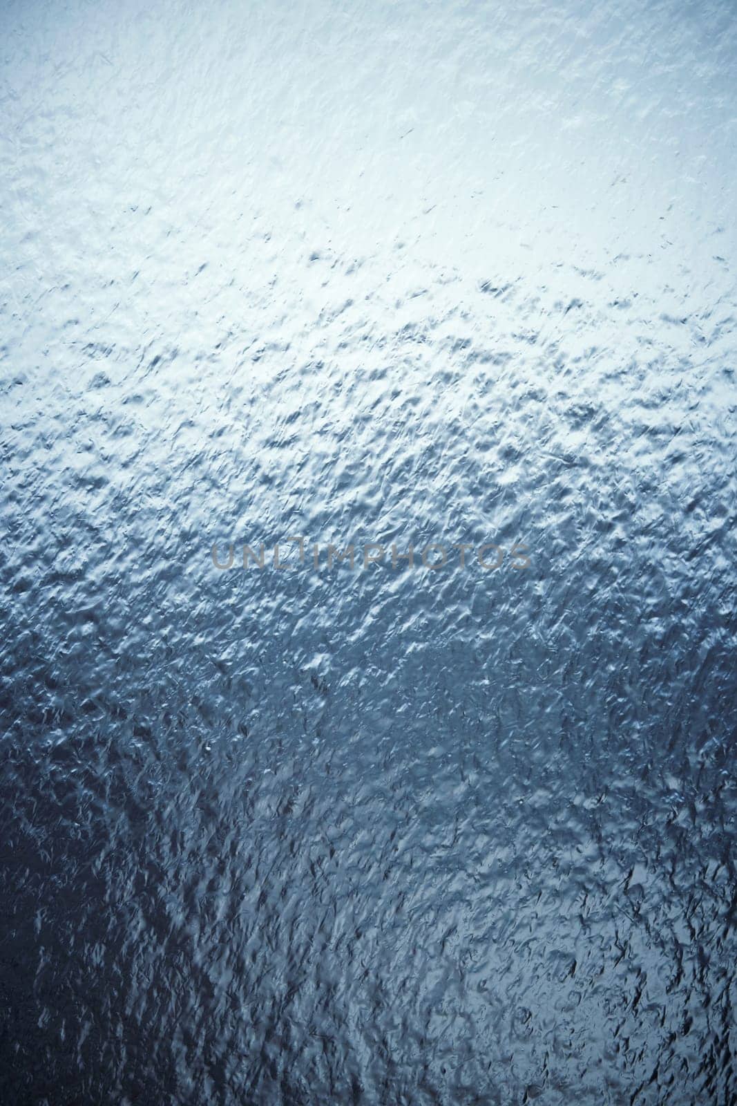 Freezing rain on a window, ice on the windowpane. Frost ice patterns on a window glass. Rime on a windowpane, Bitter cold. Frosted glass window. Ice Background by EvgeniyQW