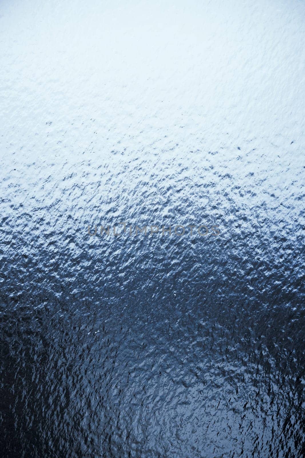 Freezing rain on a window, ice on the windowpane. Frost ice patterns on a window glass. Rime on a windowpane, Bitter cold. Frosted glass window. Ice Background by EvgeniyQW