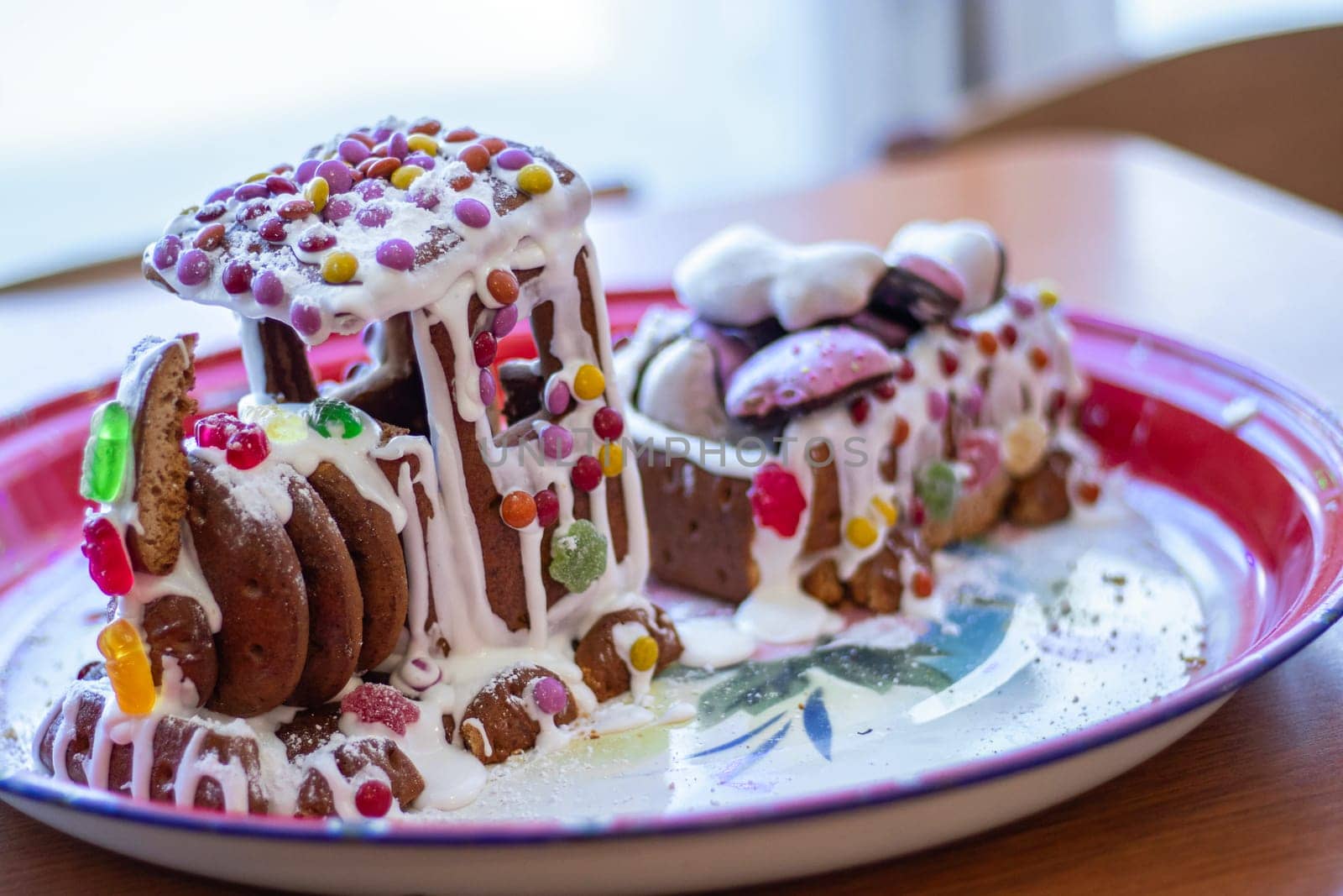 homemade gingerbread train, decorated with candies and marmalade on a colored tray