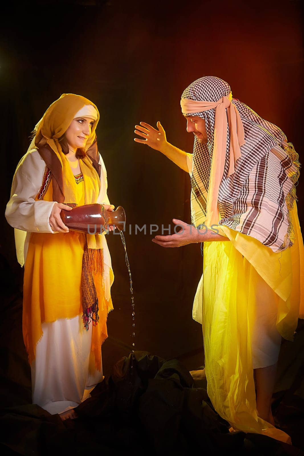 A couple in love or a married couple in stylized Eastern clothing from Israel, Palestine, Iran, Pakistan together. Tender photo session in the style of the Middle East and the Bible